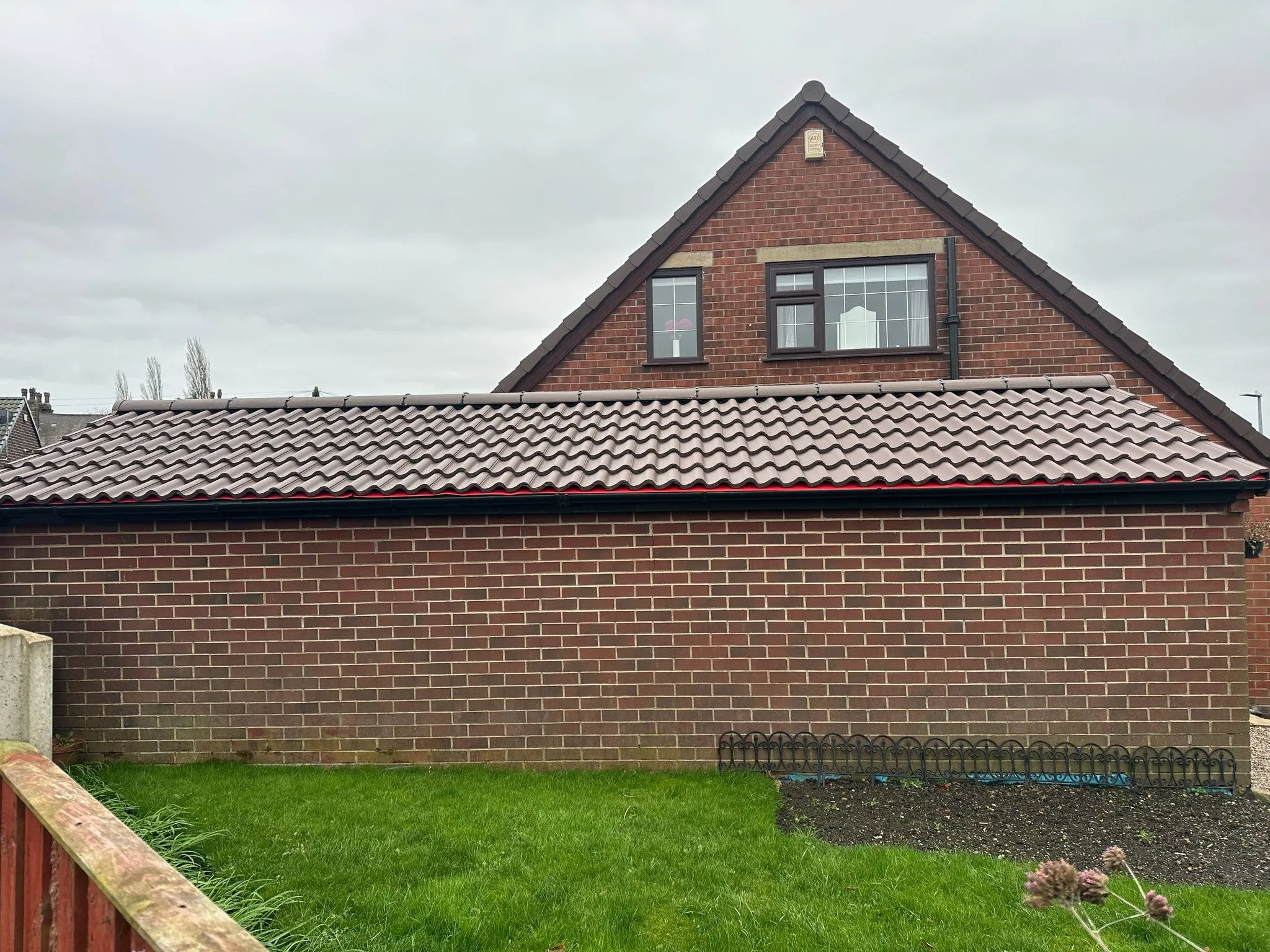 Tiled pitched roof on a brick extension