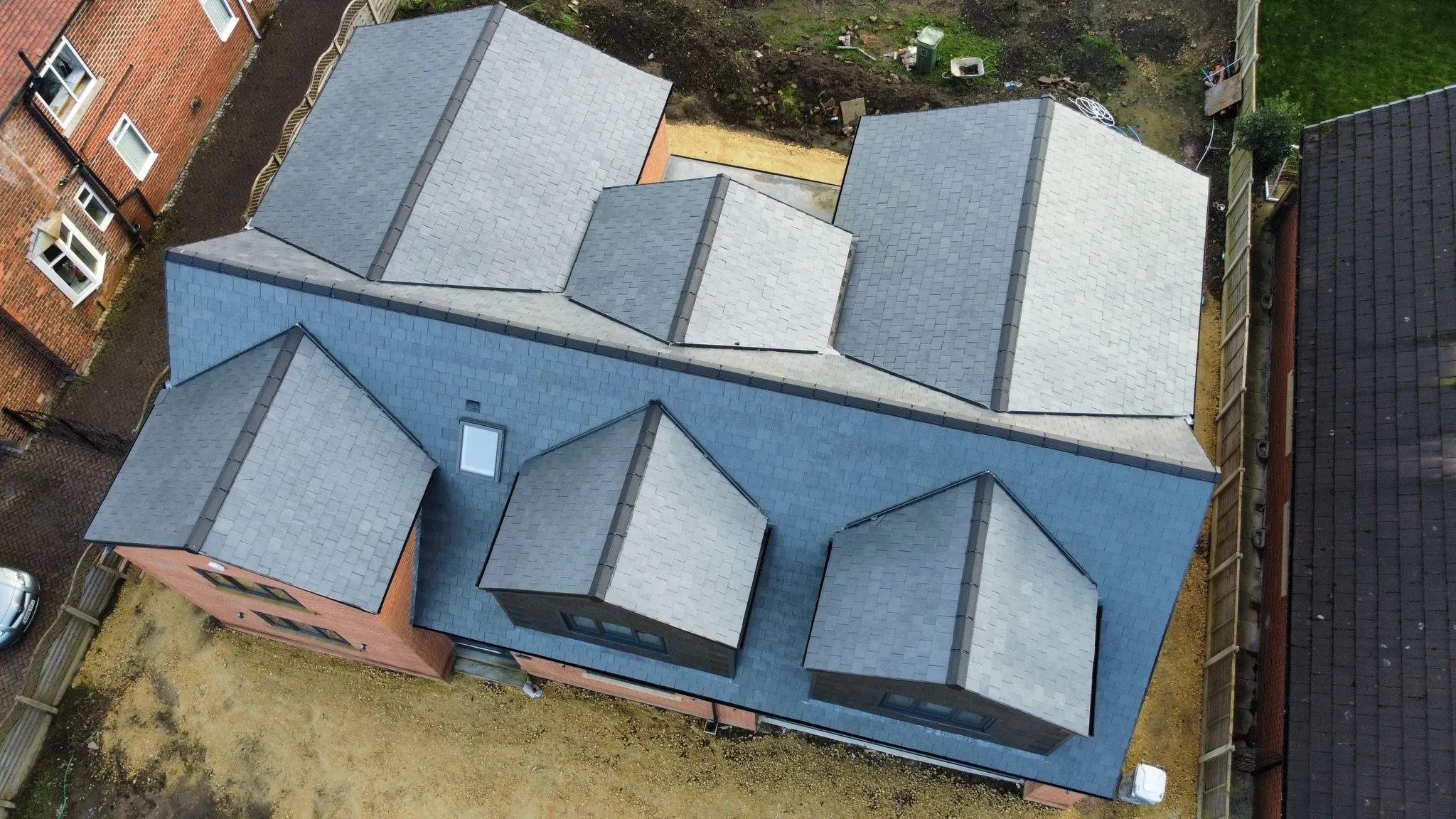 Multi-gable slate roof on a new build seen from above