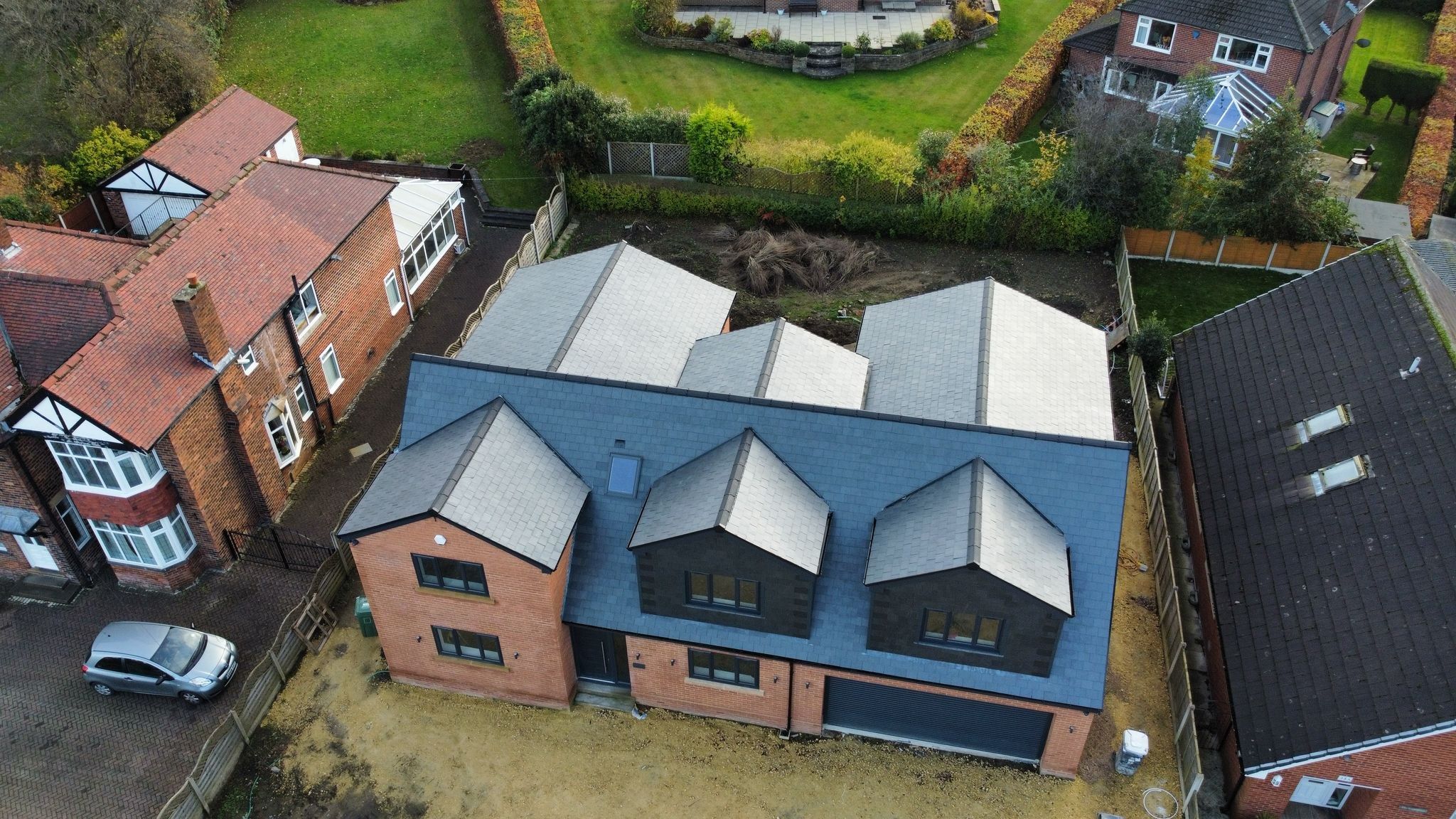 Aerial view of a new build slate roof with three dormers