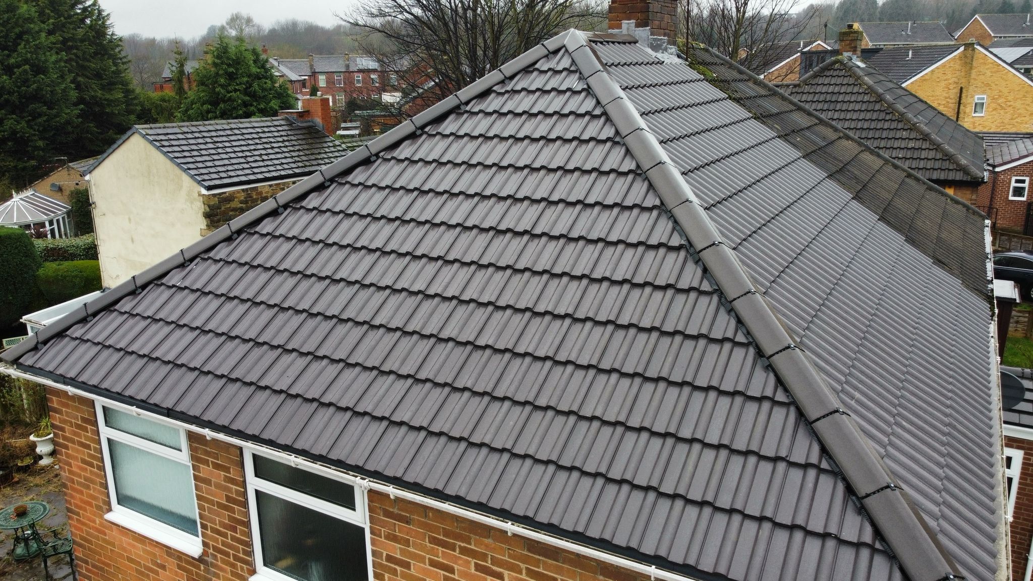 Completed concrete tile hip roof on a semi-detached house