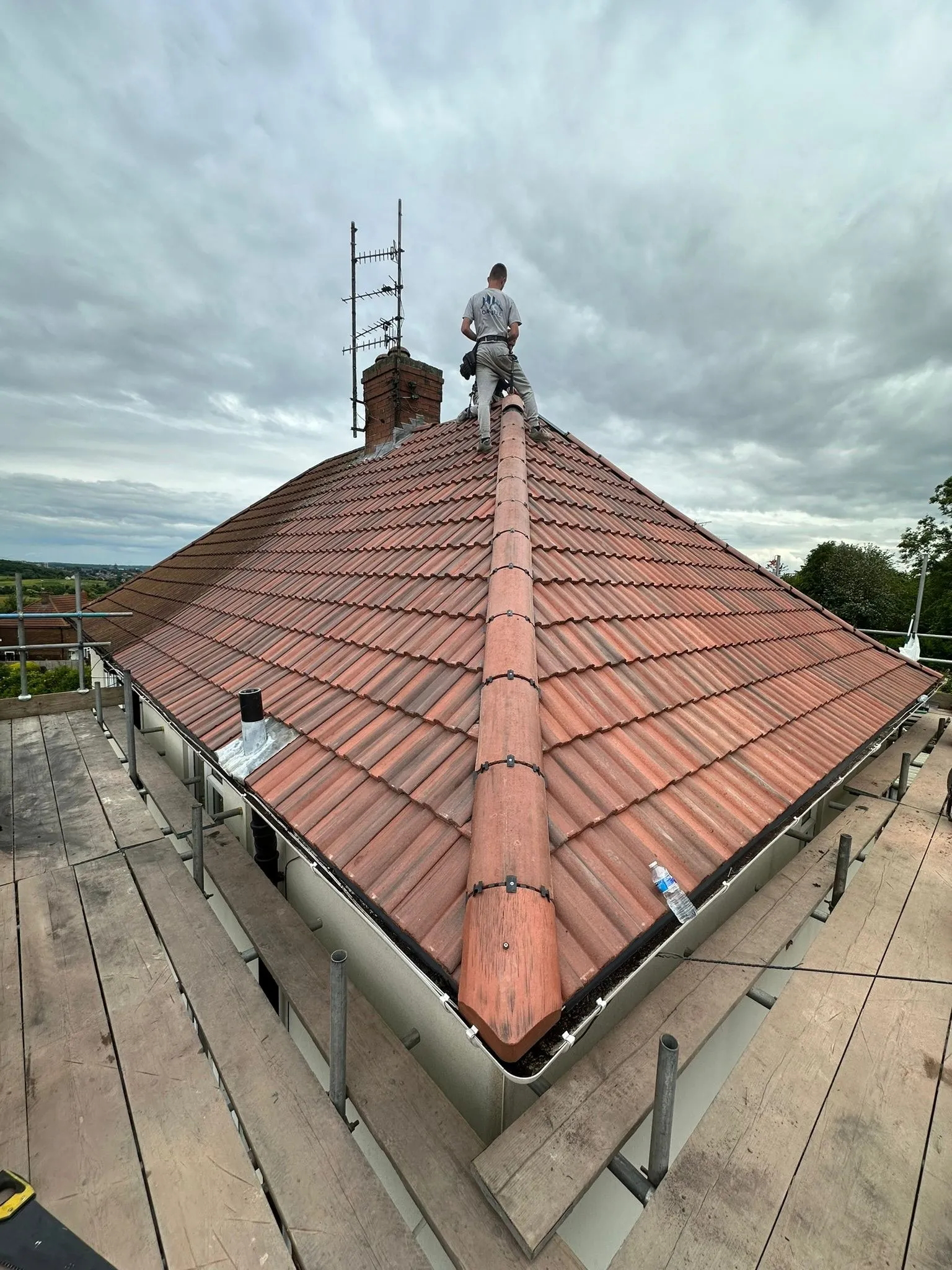 Lewis on the ridge of a terracotta tile roof
