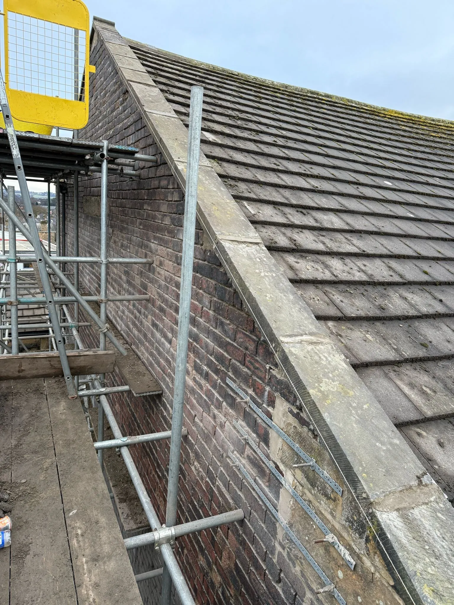 Stone verge and slate roof from the scaffold